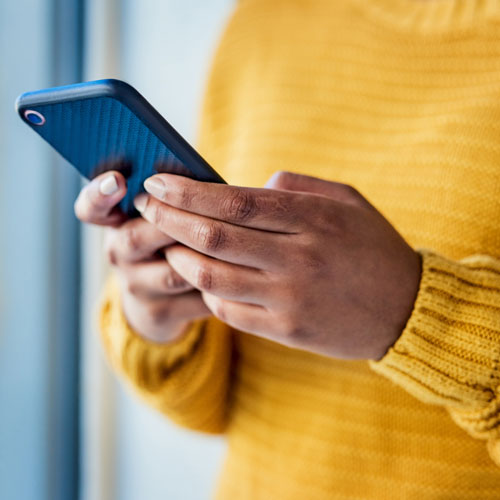 Woman in yellow jumper using app