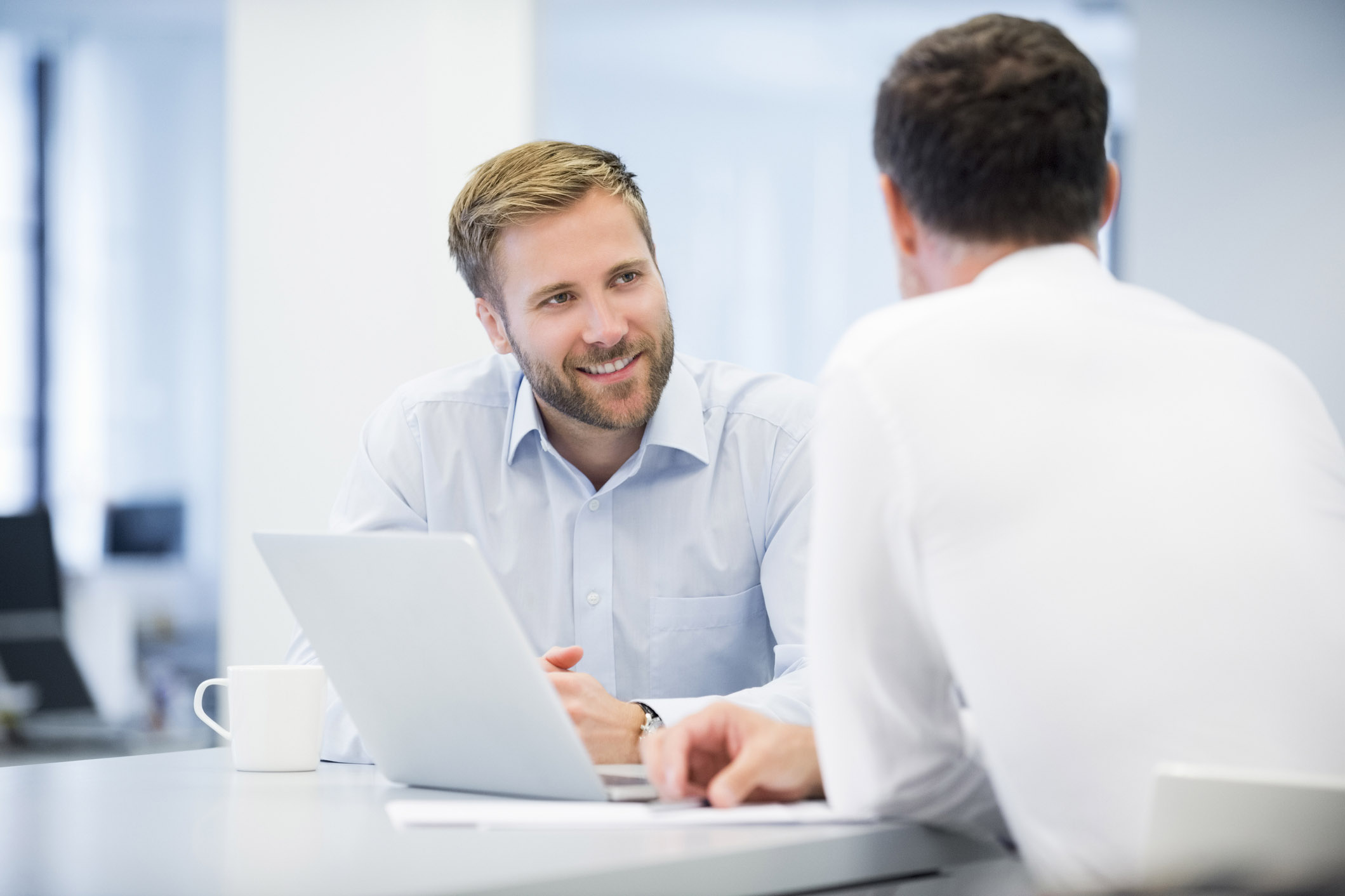 Businessman Discussing With Male Colleague face to face meeting