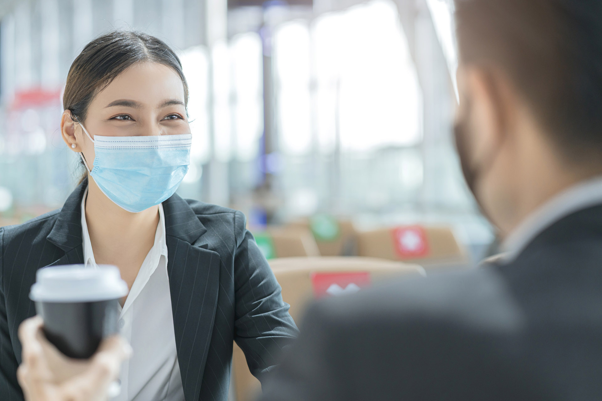 businessman and woman with face mask protection casual meeting at social distancing seat at airport terminal new lifestyle business concept traveller wearing a face mask