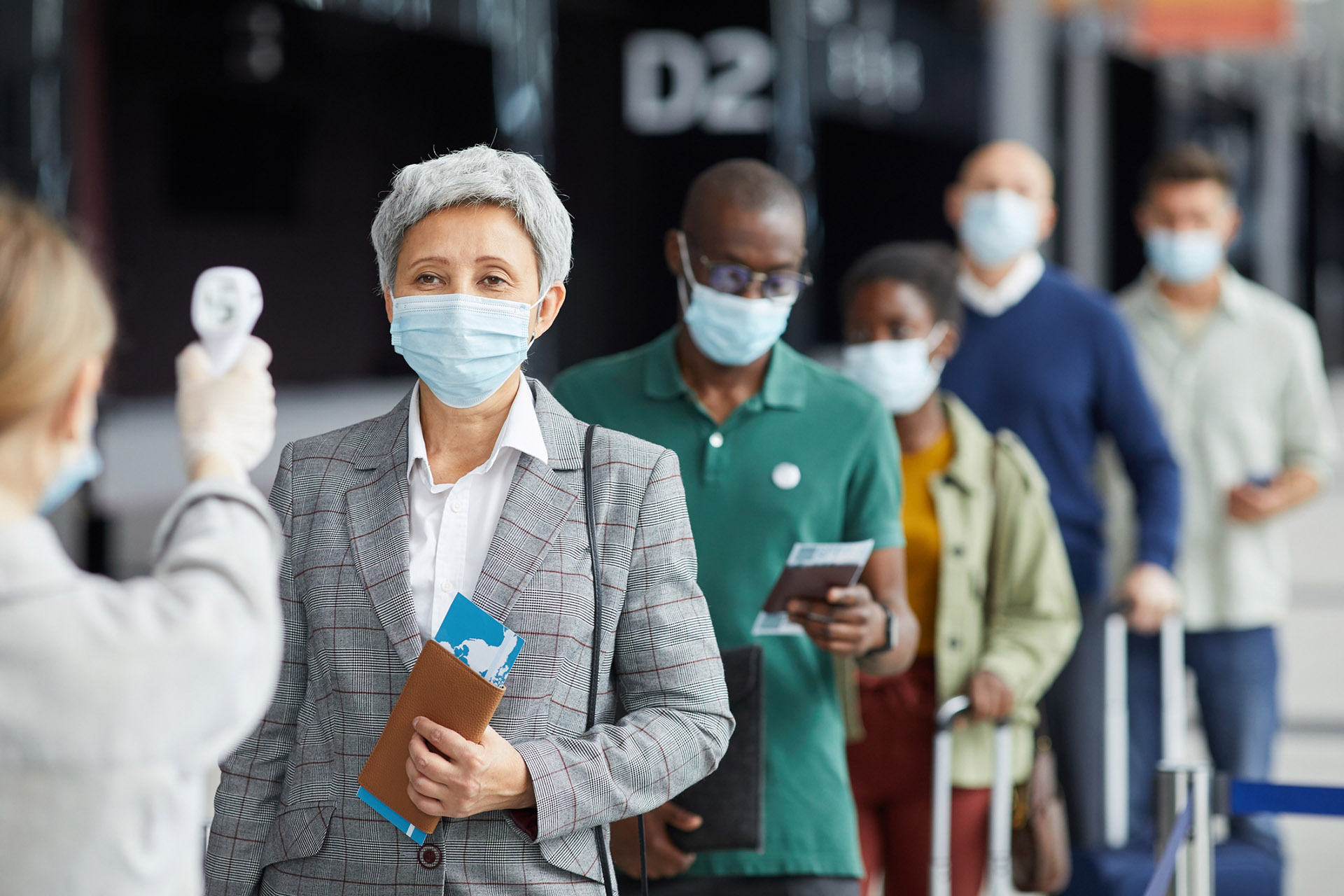 People testing at the airport business travellers at flight check-in