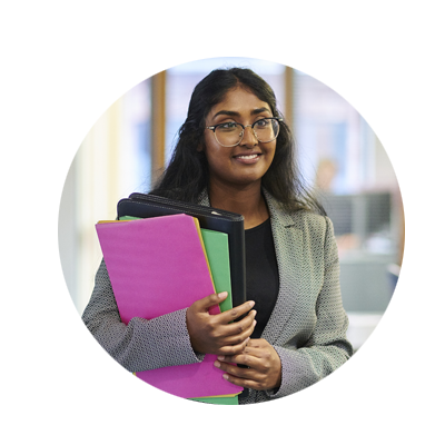 Indian female lawyer smiling while carrying colourful sheaf of documents