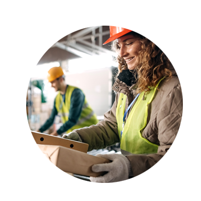 Circular Photo of a female warehouse worker surveying a cardboard box while smiling
