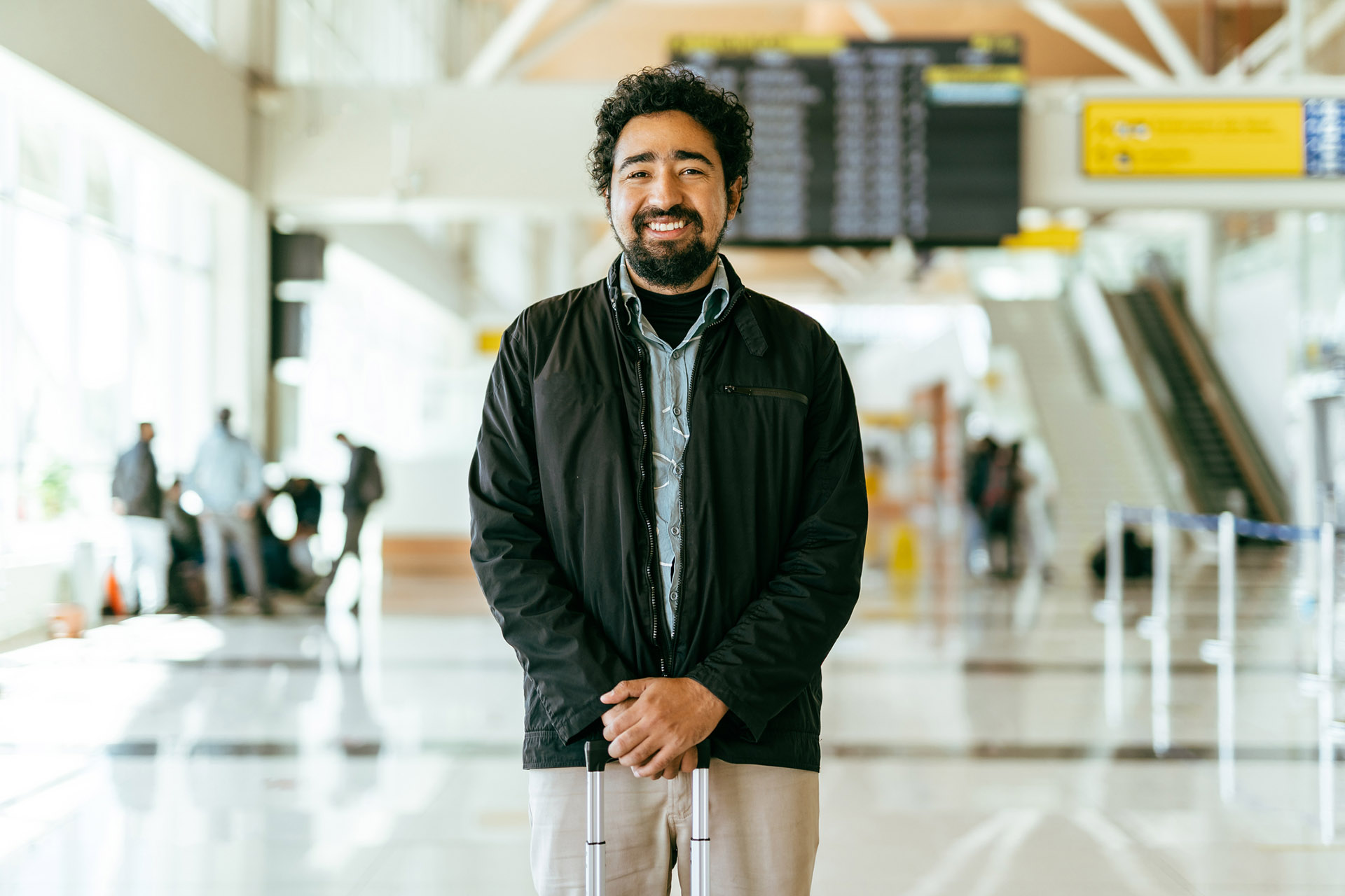 Smiling man at the airport terminal happy business traveller