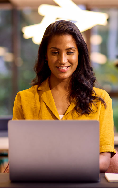 Woman in Yellow on Laptop