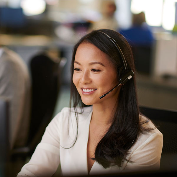 Young woman at call centre on the phone to a customer