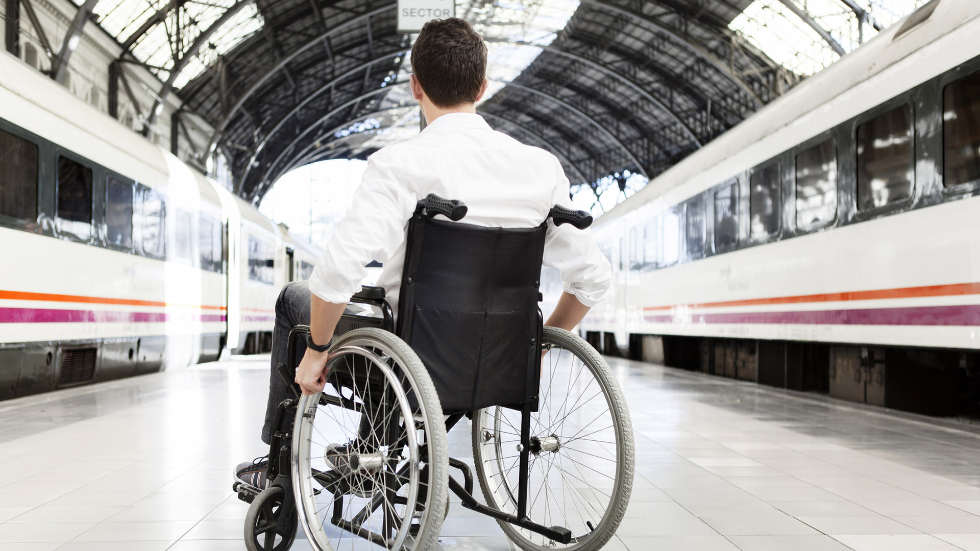 wheelchair traveller waiting for a train