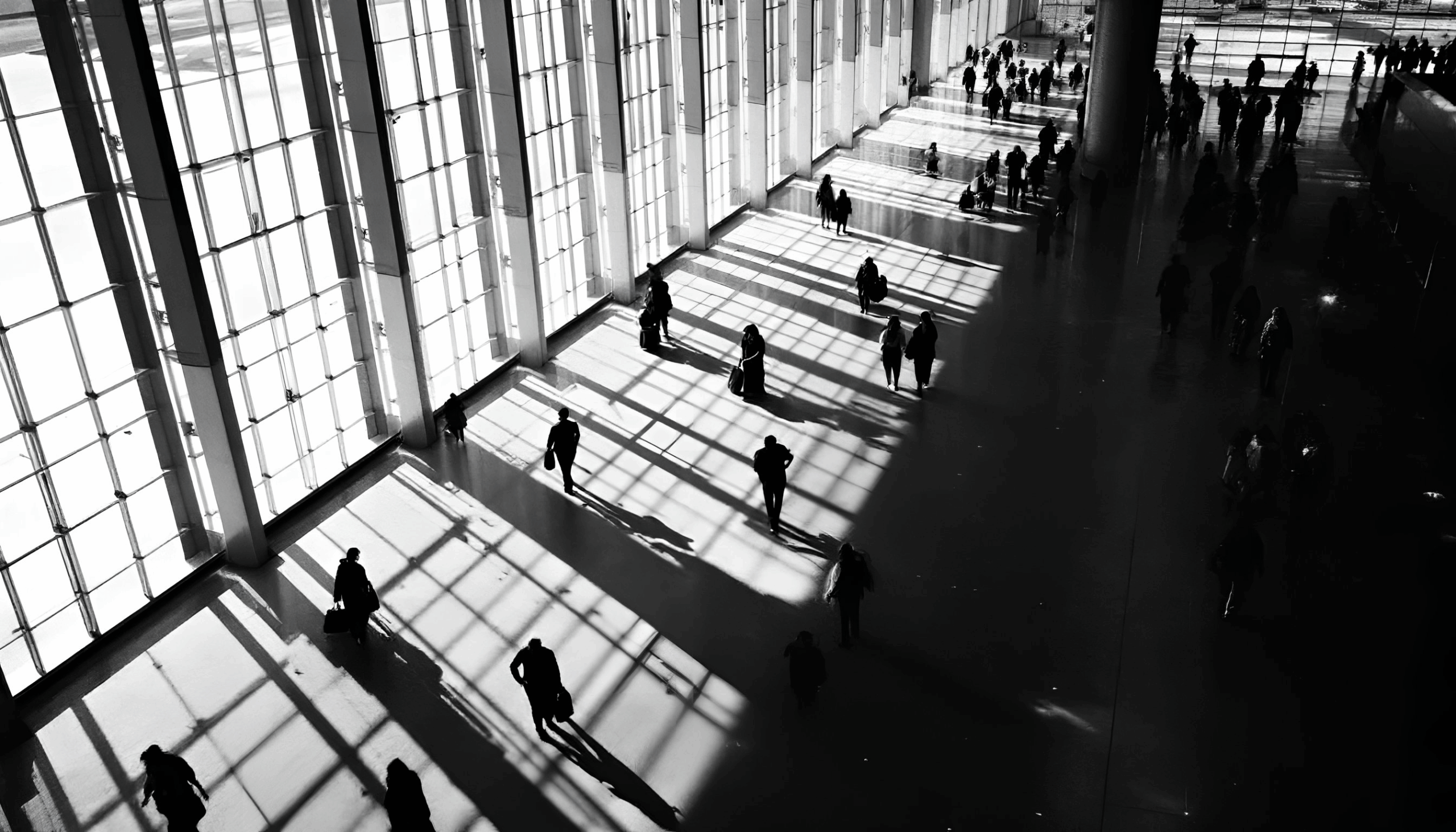 Business travelers walking across airport with wheelie cases