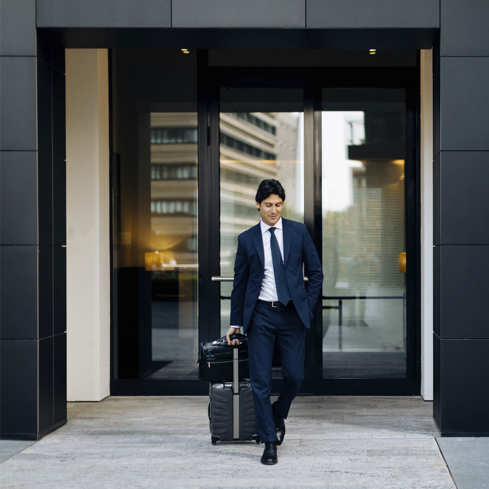 Businessman-Exiting-a-Modern-Hotel-(WEB)